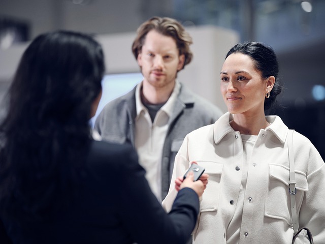 Car dealer handing keys to potential clients
