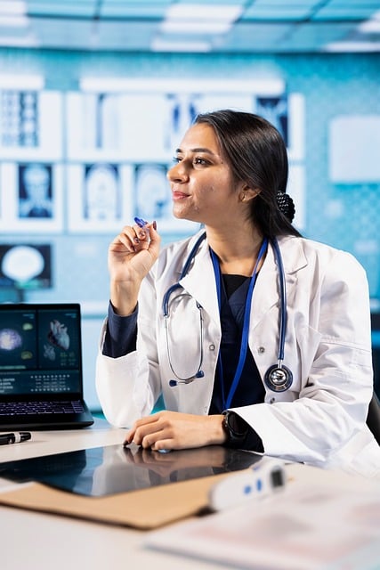 Doctor working beside a computer in a clinic setting